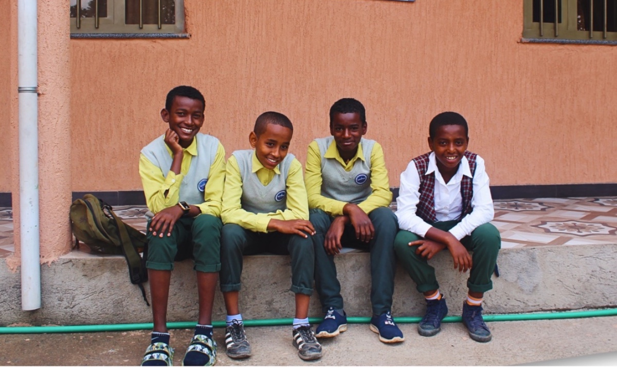 Robel, Eyob, Kirubel, and Yared are all gathered, awaiting their midday meal before heading off to school. In this vibrant hub of our community, these young scholars fuel up with delicious food and good company before continuing their education. 
#CommunityLove #EducationMatters