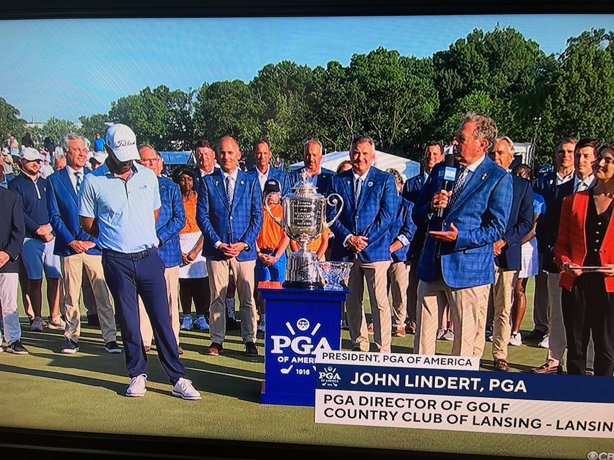 Lansing’s own John Lindert, PGA president, presenting the trophy.