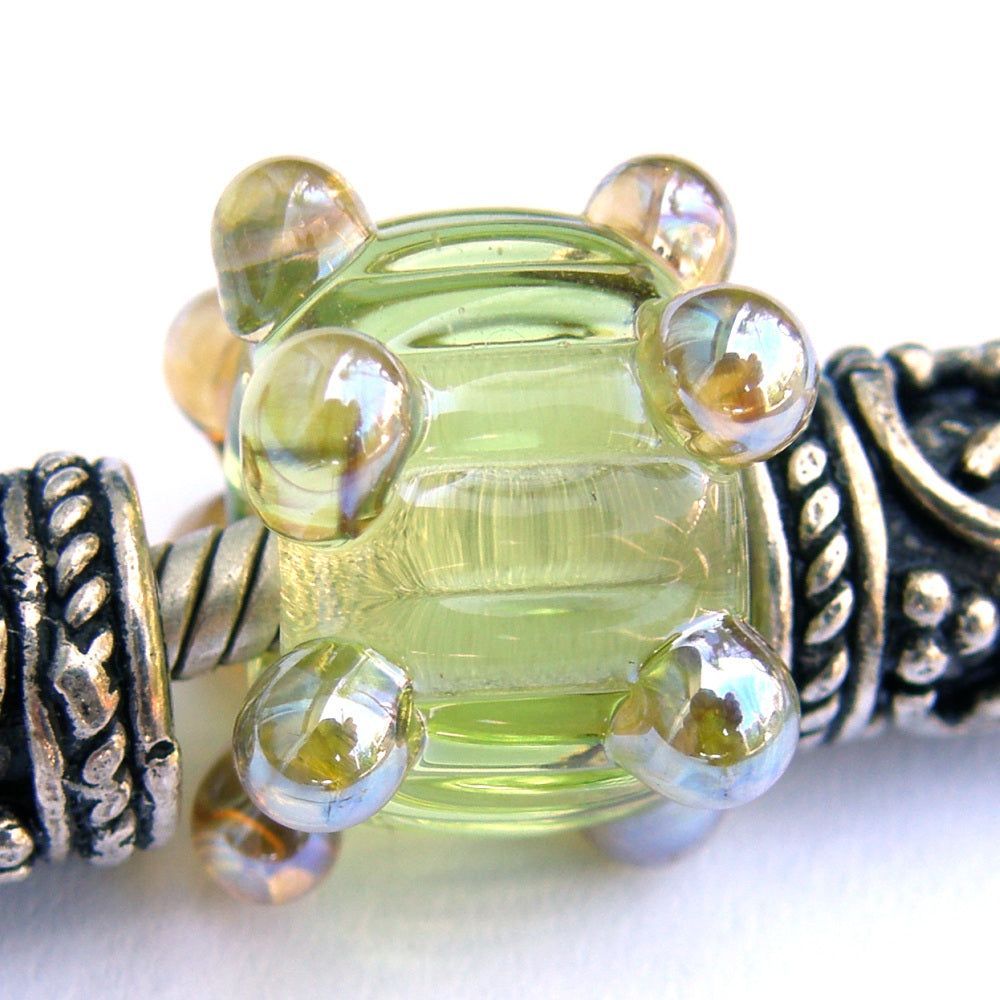 Chartreuse yellow green handmade large hole lampwork glass bead with ripples and raised metallic aurae dots bit.ly/ChartreuseRipp… via @Covergirlbeads #ccmtt #LargeHoleBeads #BraceletBeads