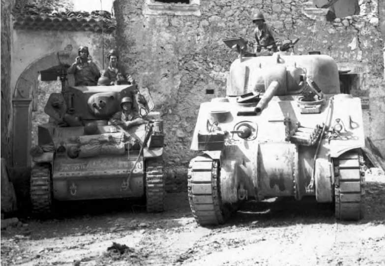 M5 Stuart light Tank {Left} M4 Sherman Medium Tank {Right} both of the 755th Tank Battalion, 2nd Armored Group, 5th Army in Coreno Ausonio, Italy,on May 14 1944.