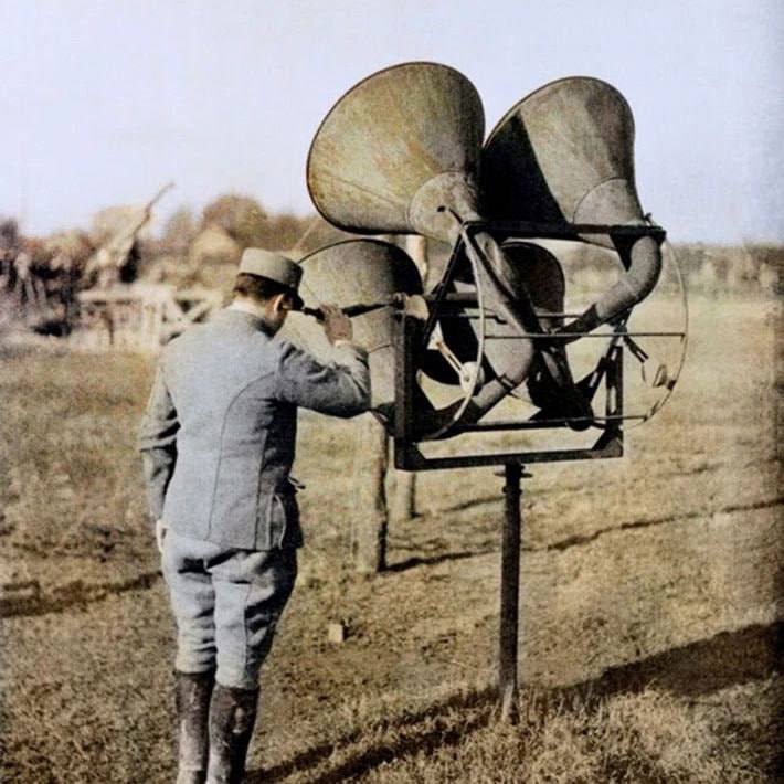 A French soldier uses a device to listen to planes at the front.