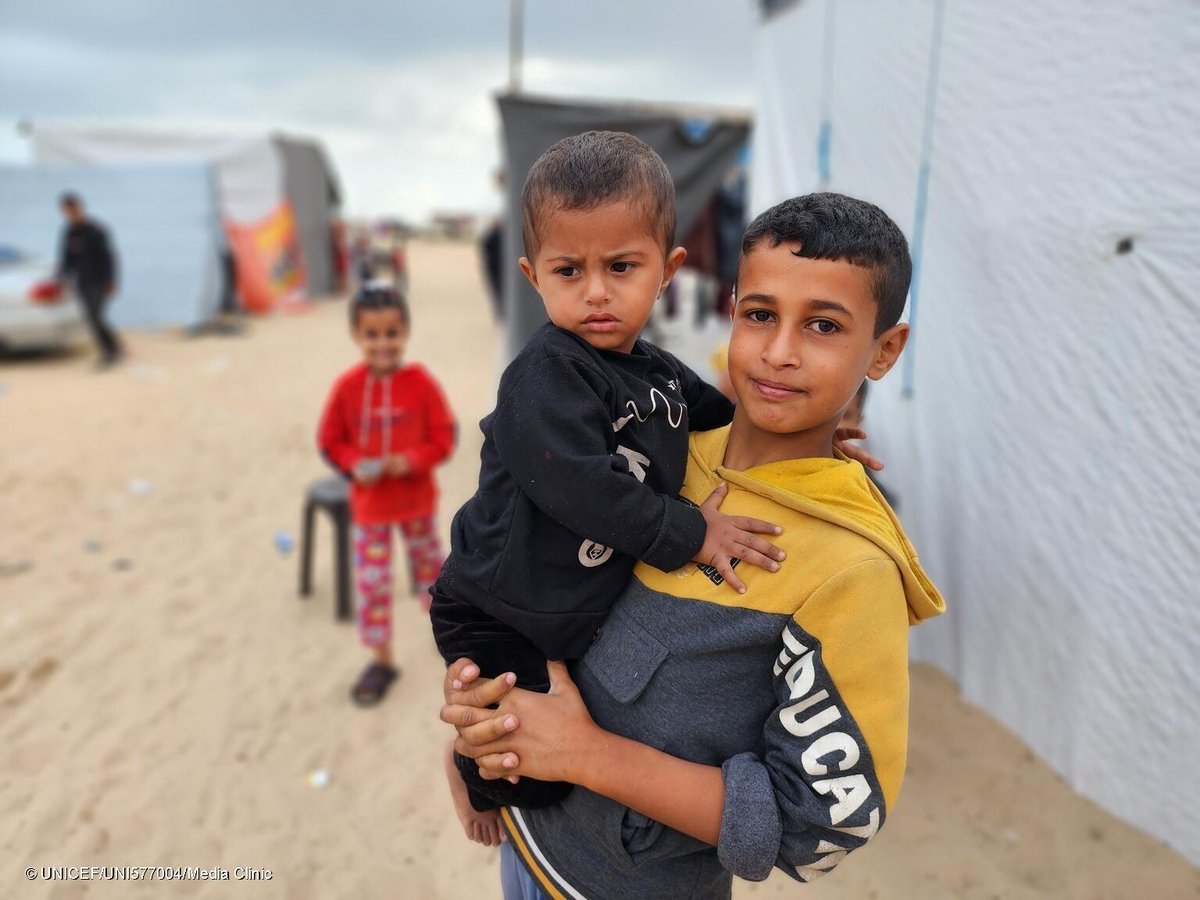 'Since the beginning of the war, my family has been displaced four times,' says Mohammad, 14, holding his brother, Khaled, 2. 'This war has lasted for a long time, and I am afraid for Khaled.' Gaza's children have endured unimaginable horrors. They need a ceasefire NOW.