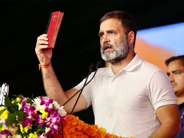 himantabiswa's tweet photo. Rahul is displaying a red Chinese constitution to the people attending his meetings. 

Our constitution, in blue, includes a chapter called the Directive Principles of State Policy, which makes it a sacred duty to enact a Uniform Civil Code in our country; Rahul is now opposing this. 

That's why I am sure that the constitution in his hand must be a Chinese one.