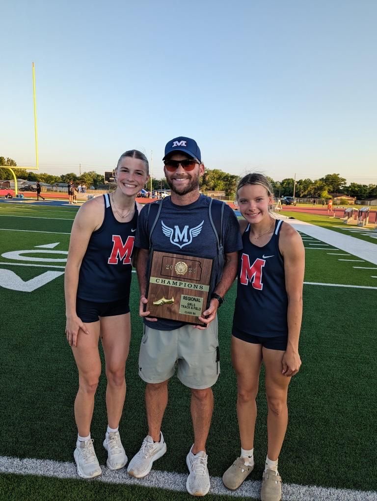 Two of the Very Best in Kansas: Hanna Pellant and Harli Omli of Manhattan (6A) pictured with Coach Kory Cool. Hanna broke her own school record with 11.68 in the 100 to win and it’s the number one time by a KSHSAA HS athlete in Kansas. Harli broke her own school record with 55.97