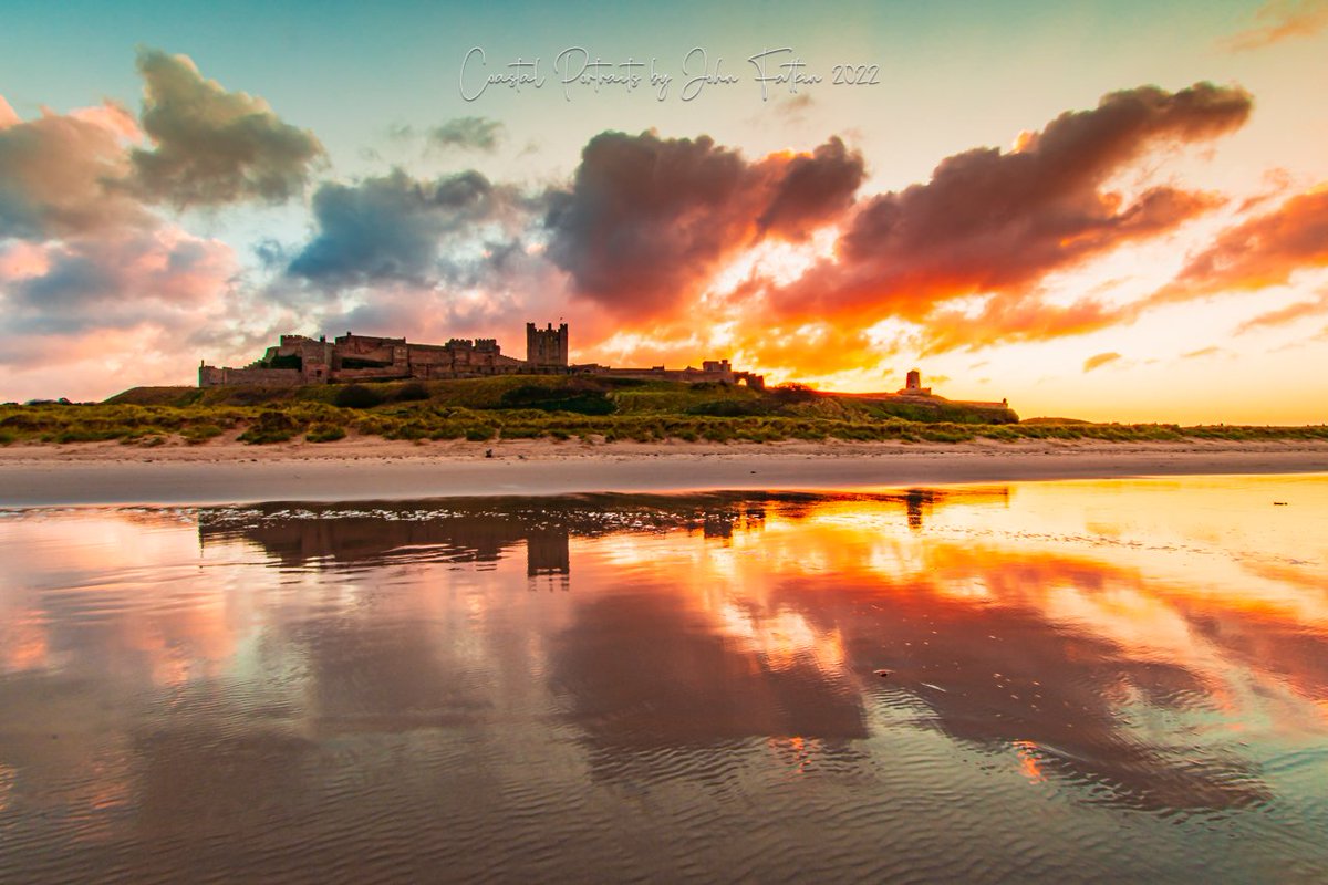 Reflections at sunset on Bamburgh Beach, the castle looking magnificent and imposing #stormhour #sunset #Weather #photography