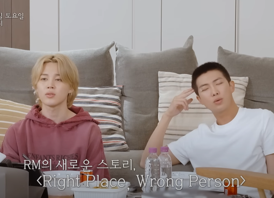 Jimin and RM of BTS in a new teaser, listening to 'Right Place, Wrong Person'.