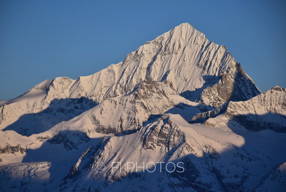 Dent Blanche 4,358m ©️ Fi Photos. A similar perspective with a very different time of day on a perfect morning 04/04/23 #DentBlanche #valais #penninealps