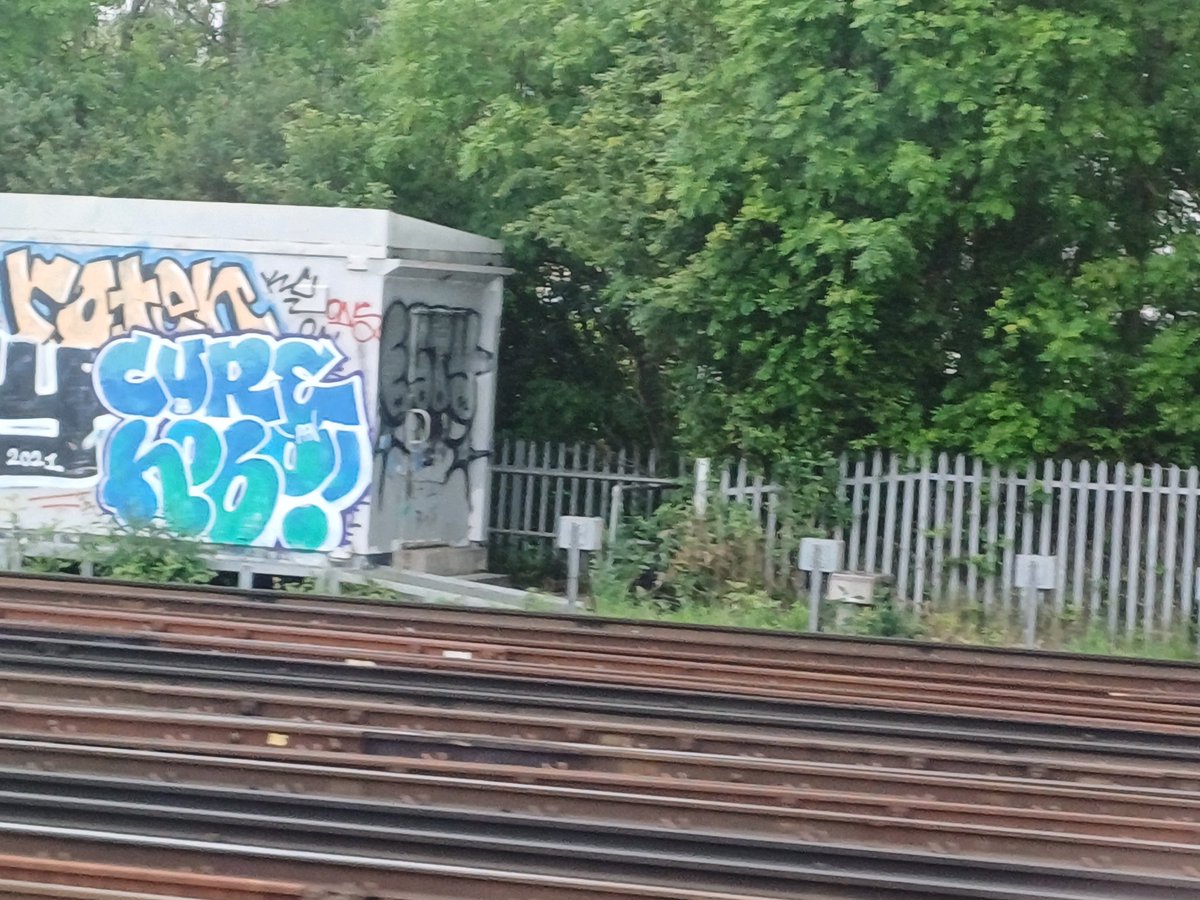 Managed to just about snap The Cure graffiti on the moving train just past Clapham Junction.