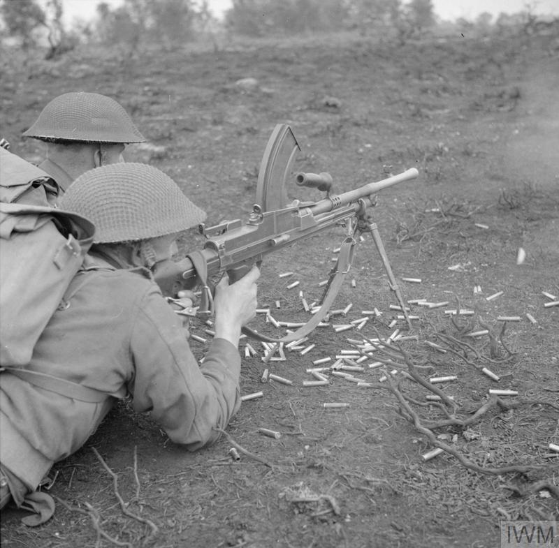 A Bren gun team are pictured in action at a battle school in Eastern command, 14 September 1942. Taken by War Office photographer Lt. Len Puttnam. © IWM (H 23829)