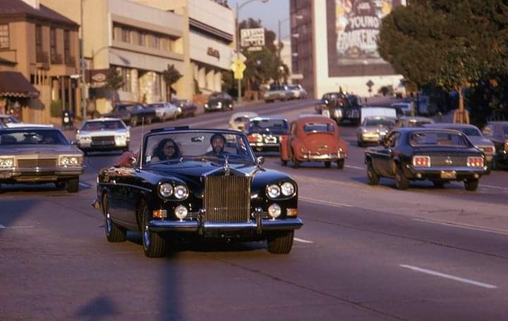 Oh my god. 1974/5. A Rolls Royce Silver Cloud III Drophead Coupé (top down) cruises down Sunset Boulevard, past the poster for the newly-released Young Frankenstein. Oh, and the driver is Marvin Gaye.