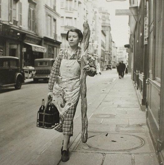 A French woman with her baguette and six bottles of wine, Paris, 1945.🥰 #oldphotos #vintage