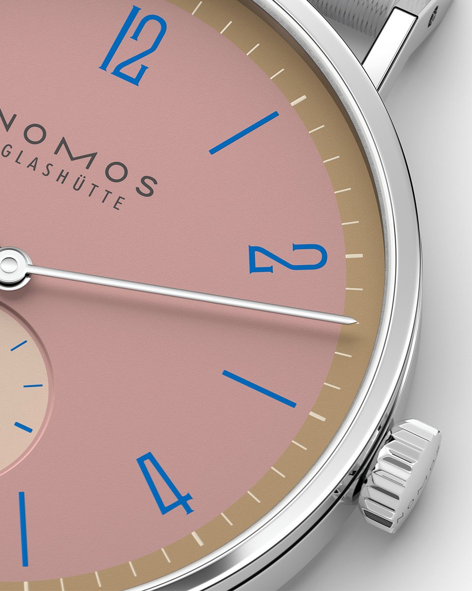 Dusky pink, framed by dark gold, with hour numerals and markers in royal blue. The sub-seconds is cream-colored, also with blue indexes. nomos-glashuette.com

#Tangente 38 #Pompadour is available at selected #NOMOS retailers.