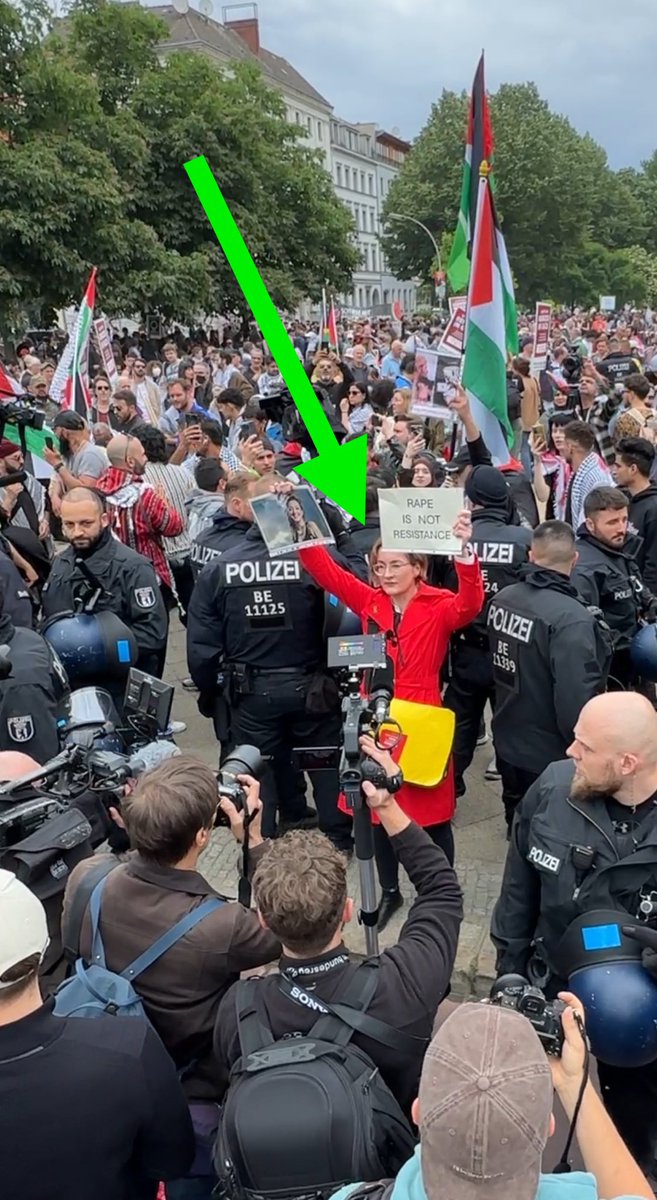 Be this woman! 💪 

Surrounded by a pro-Hamas mob in Germany, she holds up a picture of Shani Louk (who was Israeli - German) and a sign that says ‘Rape Is Not Resistance’.