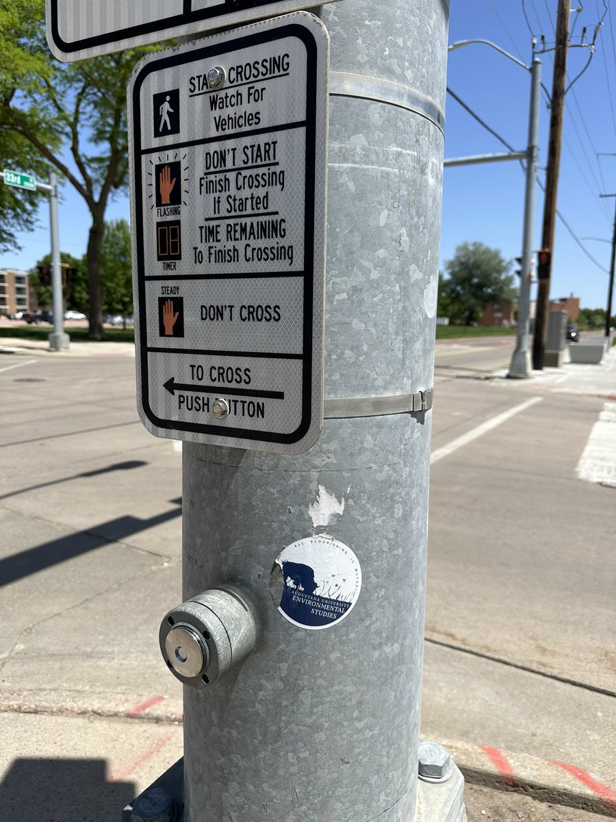 A little creative decoration by some <a href="/AugieEnviro/">Augustana University Environmental Studies</a> students? The mortarboard was surely one of my students. Not sure about the sticker by the light post.