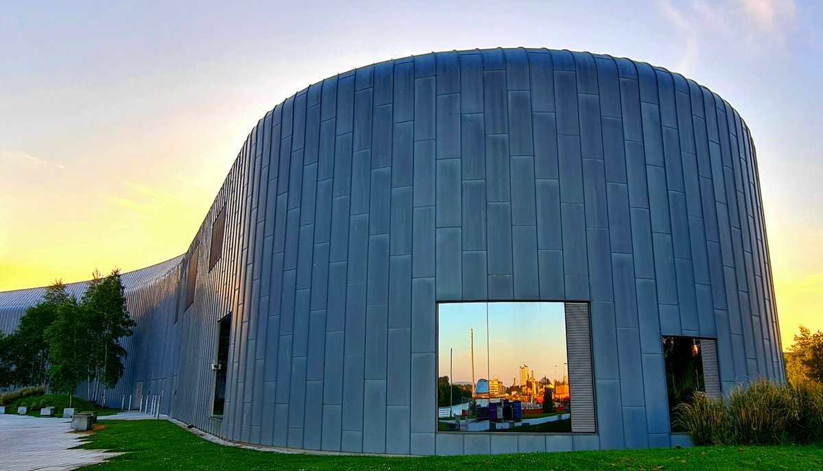 Sunset at Glasgow's Riverside Museum. Designed by Zaha Hadid, it was first opened in 2011. The reflections in the window shows the buildings of the Clyde Waterfront further up the river. #glasgow #architecture #glasgowbuildings #sunset #riversidemuseum #glasgowsunset #zahahadid