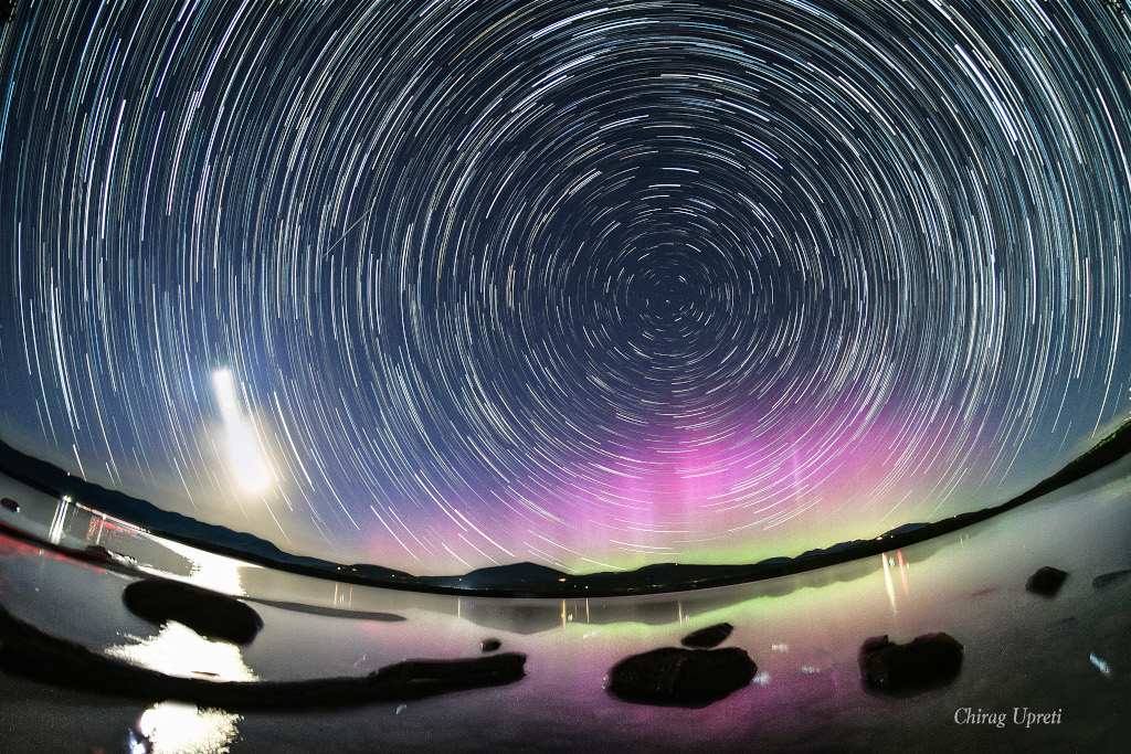 Graceful star trail arcs reflect planet Earth's daily rotation in this colorful night skyscape. To create the timelapse composite, on May 12 consecutive exposures were recorded with a camera fixed to a tripod on the shores of the Ashokan Reservoir, in the Catskills region of New