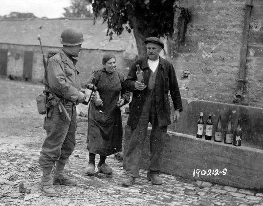 Normandy residents thank an American GI for liberating their town (in true French fashion). Happy #NationalWineDay to all who celebrate. (Full disclosure: We will be.)
