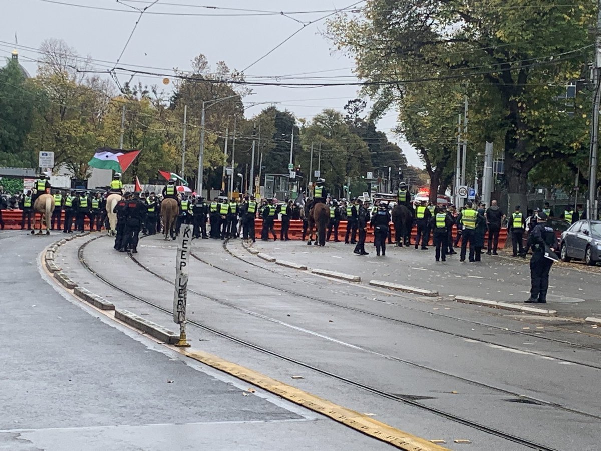 Several hundred protesters have gathered outside state parliament ahead of the “Never again is now” protest against anti-Semitism. 200m down the street a large police presence is keeping pro-Palestine protesters yelling “intifada, intifada” at bay.