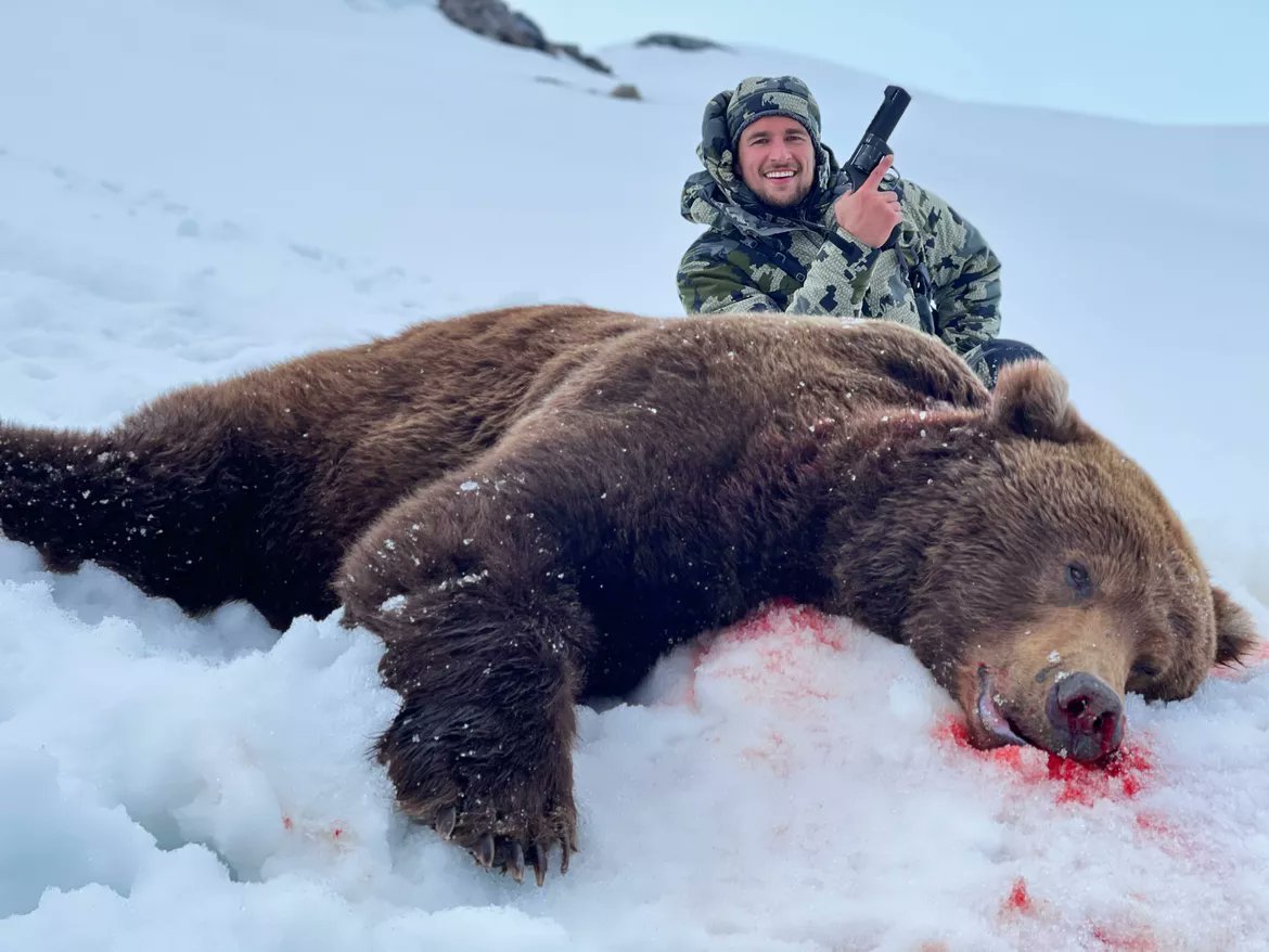 Trevor Schneider poses with the massive coastal brown bear that nearly killed him and his sister Tana Grender in May 2021 in Alaska. Such a pity. Think of all the animals that wouldn't have been killed if it had succeeded!!!! #EndTrophyHunting NOW!!