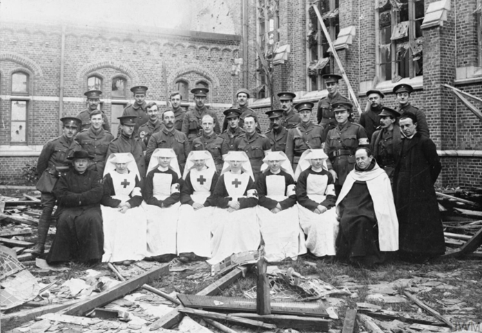 Red Cross staff of the Sacre Coeur Civilian Hospital photographed in occupied Belgium, at Ypres, January 1915. IWM Q 70223