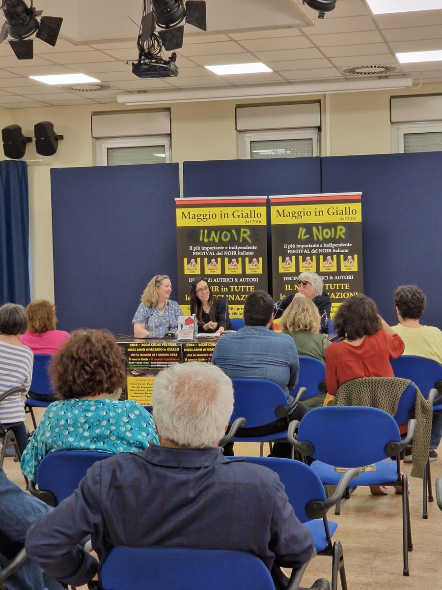 So proud of our graphic designer @TheTrionaWalsh, seen here reading at a crime writing festival in Milan!!