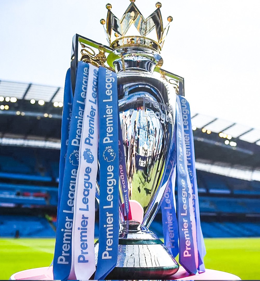 The Premier League title race between Manchester City and Arsenal has come down to the final day. Since either team could win the league—but are playing different teams—each stadium has been set up with: • Identical trophies • Expert engravers • Fireworks • Podiums •