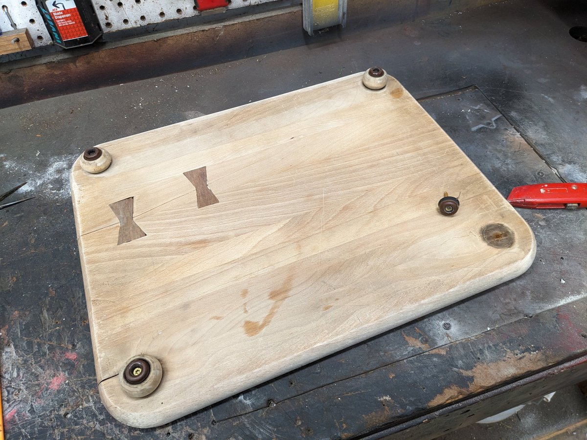 A foot on the cutting board broke.
It had broken before, I epoxied it, that lasted 6 mo, it broke again.

(The hourglass-shaped inlays are from when the board started splitting, so I pulled the crack back together with 'dutchmen' I made from hardwood flooring offcuts).