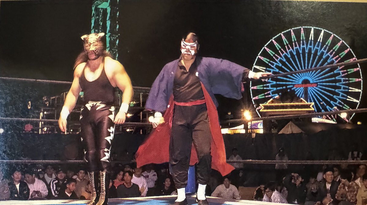 This photo of @the_greatsasuke and Black Tiger (Eddie Guerrero) at an outdoor venue (Sun Life Sports Ground and Youth Center in Gifu) on October 14th, 1994 with the Ferris wheel in the background had to be shared