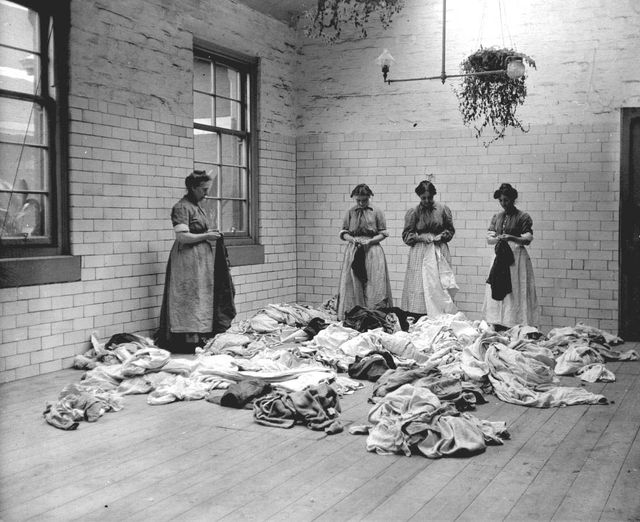 London Rd Rd, 1914 Belvidere Hospital wash house, women labelling articles of clothing for subsequent identification. Archive Ref: P193