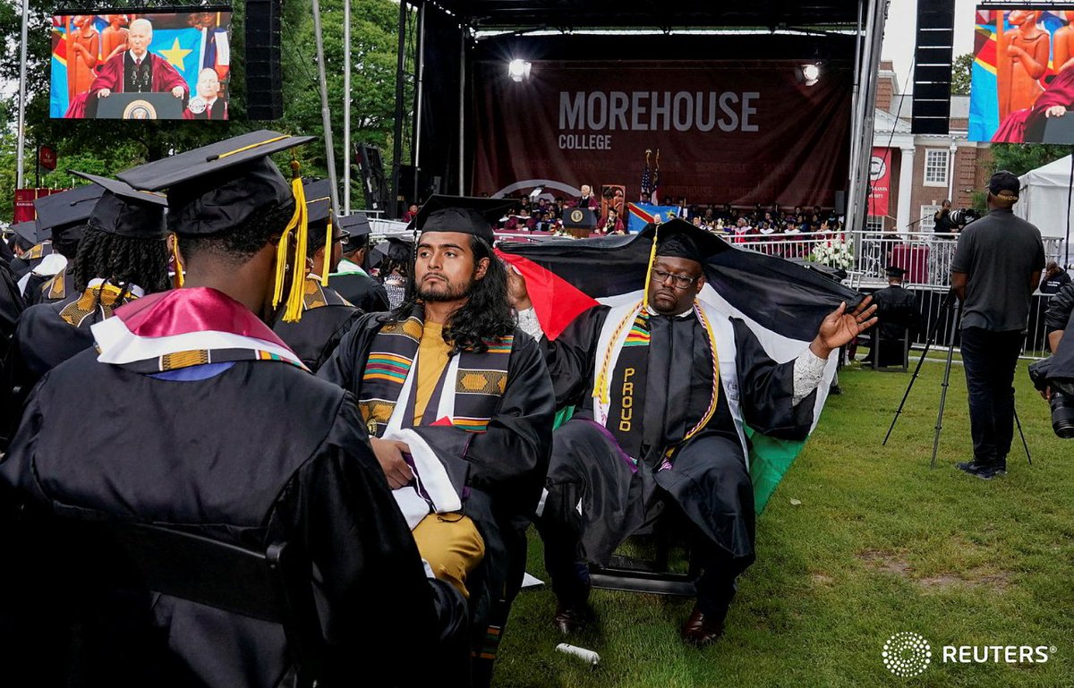 A Morehouse College graduate with his back turned holds a Palestinian flag while U.S. President Joe Biden speaks during a commencement ceremony in Atlanta, Georgia, U.S., May 19, 2024. REUTERS/Elizabeth Frantz