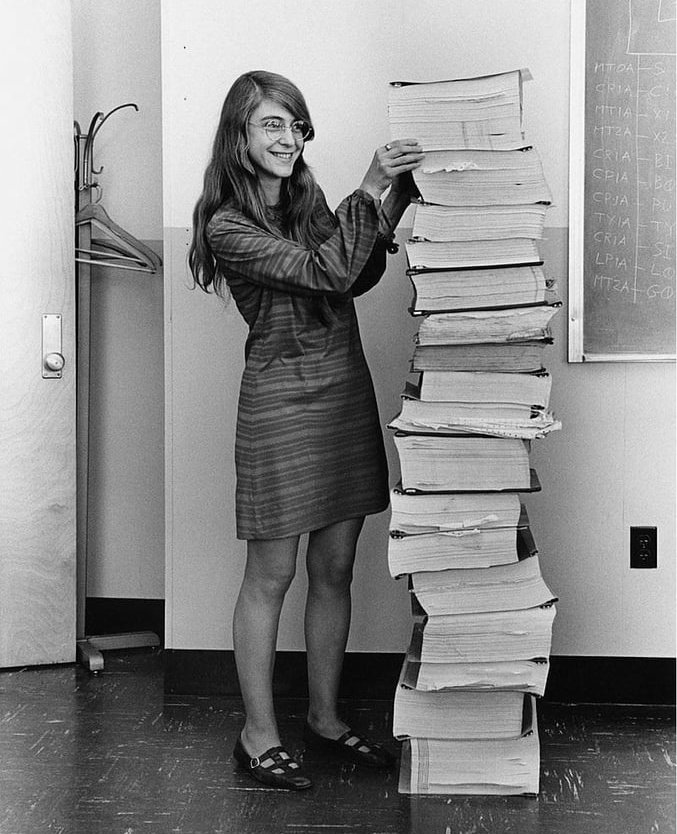 Legendary Apollo project programmer and computer scientist Margaret Hamilton, standing next to listings of the software she and her MIT team produced for the Apollo program, 1969. (MIT Museum image)