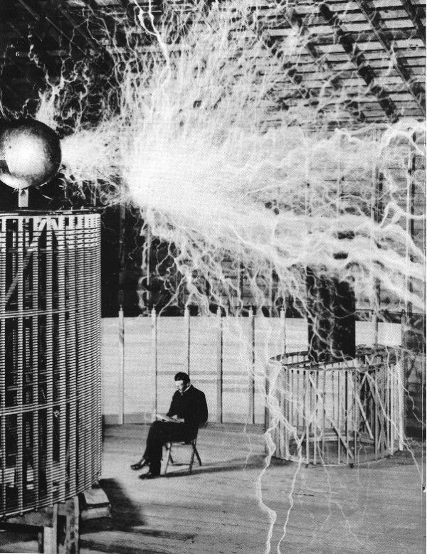 Physics Photo Of the Day: Nikola Tesla sitting in his laboratory with his 'magnifying transmitter.'