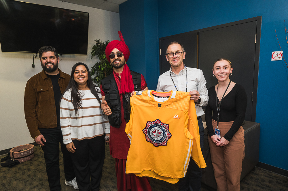 We were thrilled to welcome @diljitdosanjh to Canada Life Centre for the second time and to a fully sold-out crowd on Friday!! We gifted him with a South Asian Heritage @NHLJets jersey and an FFO Winnipeg Jets collab hoodie! 📷 @DwayneLarson