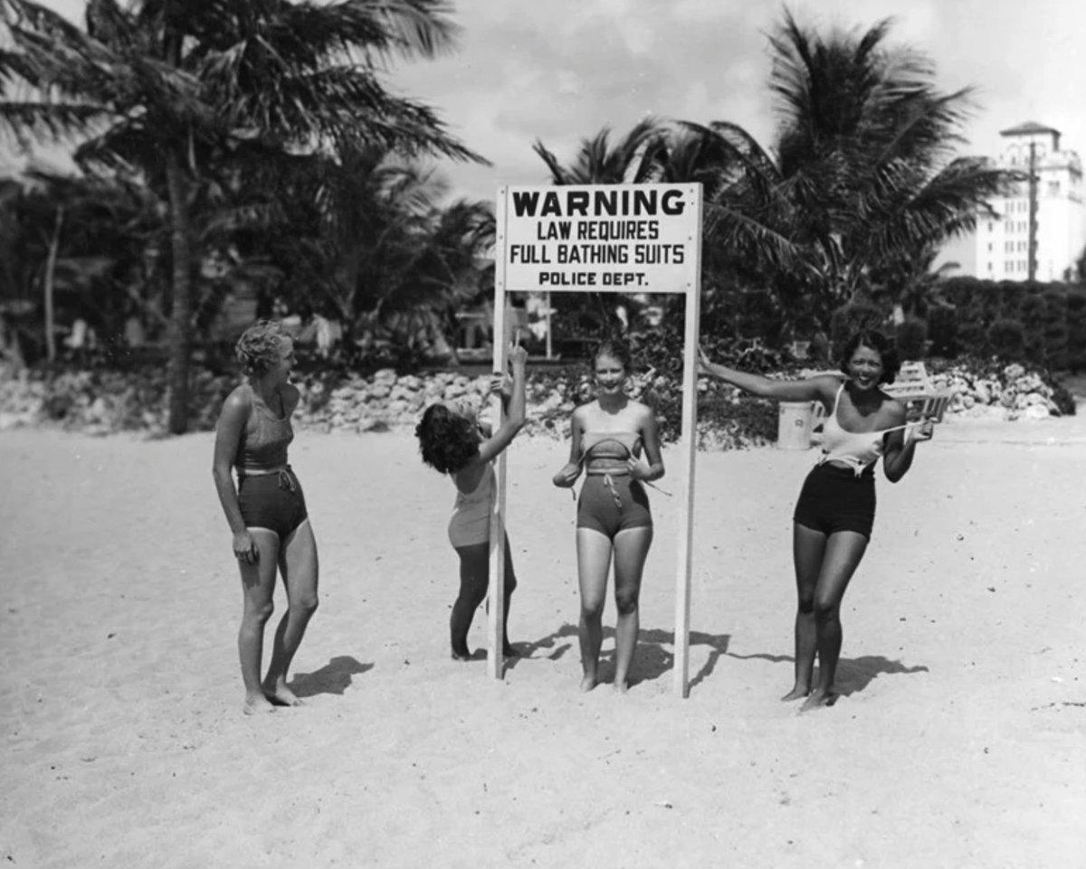Miami Beach, 1934: women ridiculing a sign 👙