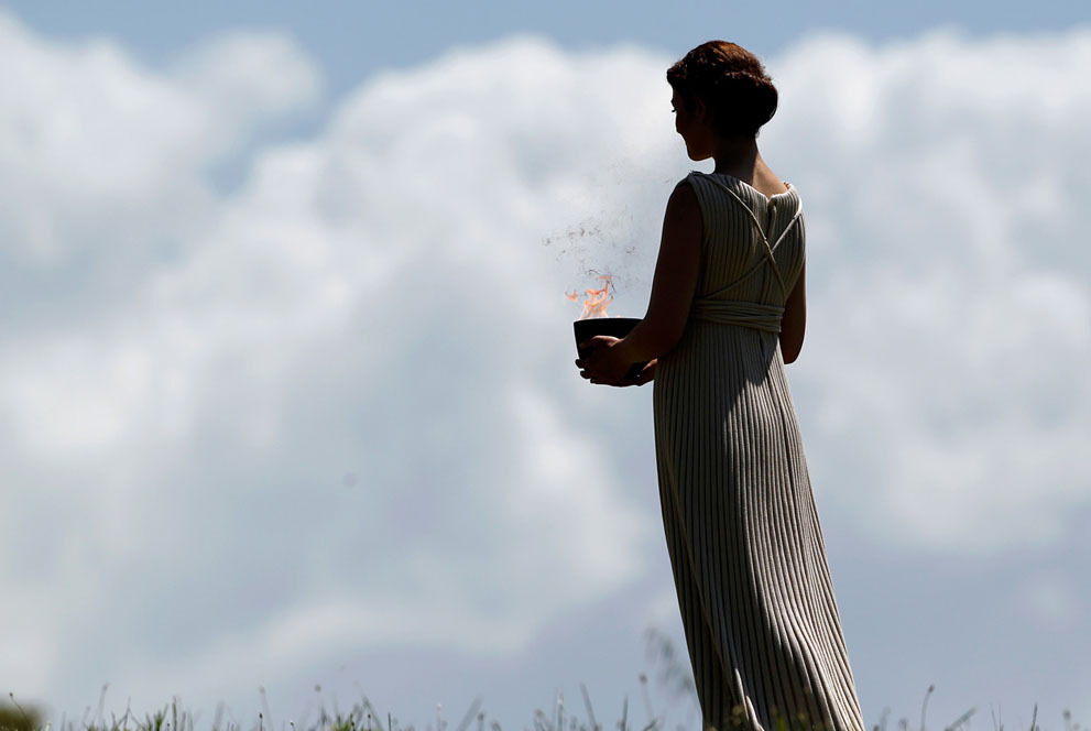 A priestess holding a metal pot performs in the final dress rehearsal for the lighting of the flame held on May 9, 2012, in ancient Olympia, Greece. AP Photo/Petros Giannakouris