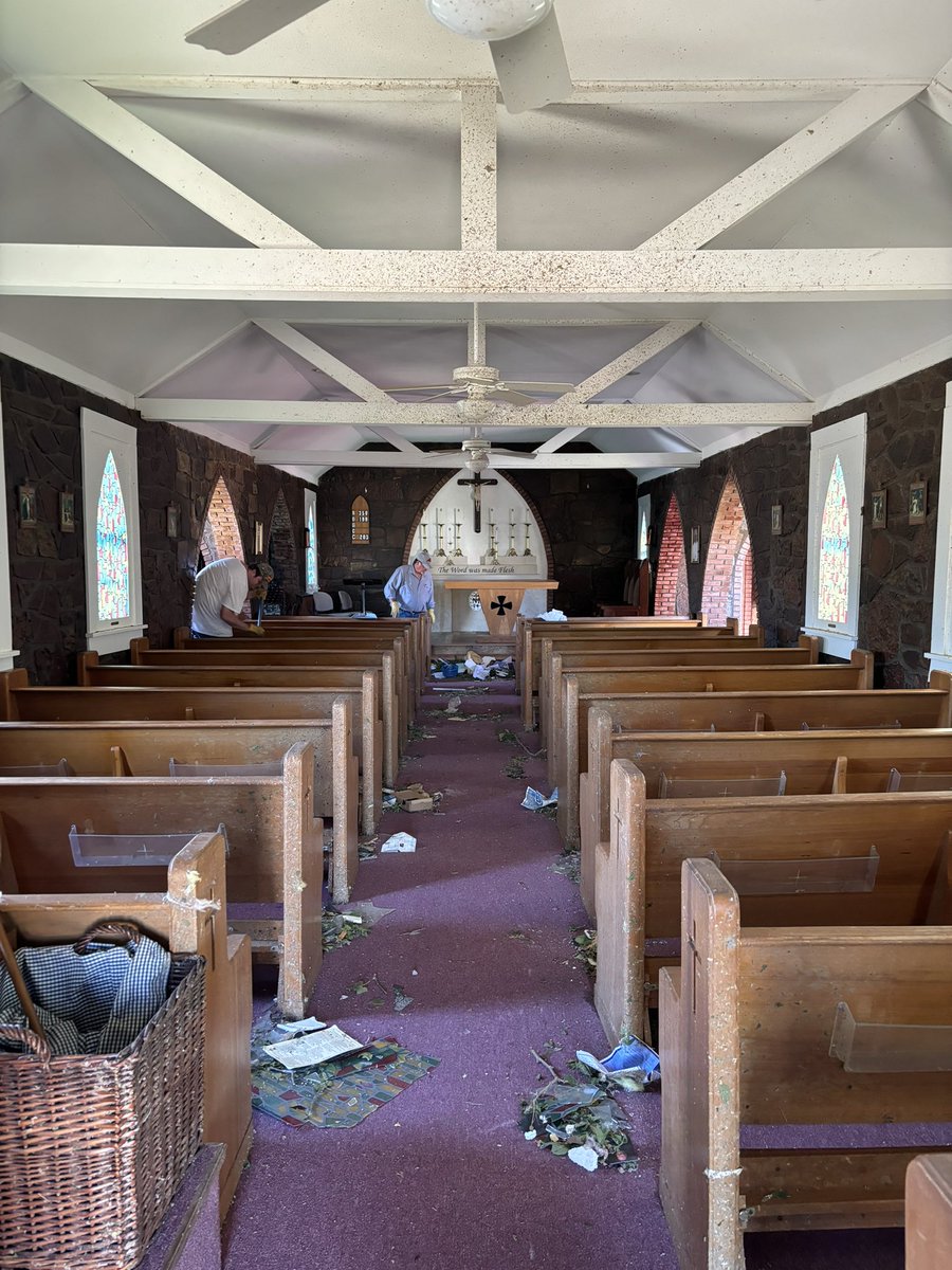 The church itself is a stone 1930s building. It held up quite well, respectively. Wind blew in the front door, blew in half a dozen stained glass windows, and blew out the back door. The inside of the church was covered in debris and glass. In the picture below, we’d…