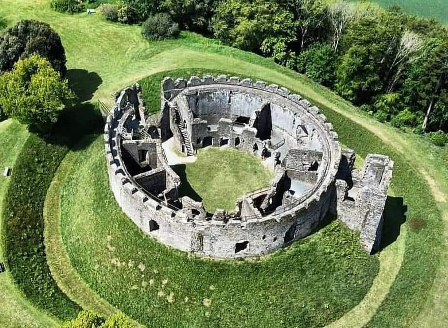 Restormel Castle, situated near Lostwithiel in Cornwall, England, was constructed around the 13th century by the powerful Norman family, the Cardinans. The castle's design features a circular layout with a central keep surrounded by curtain walls and towers. The castle is