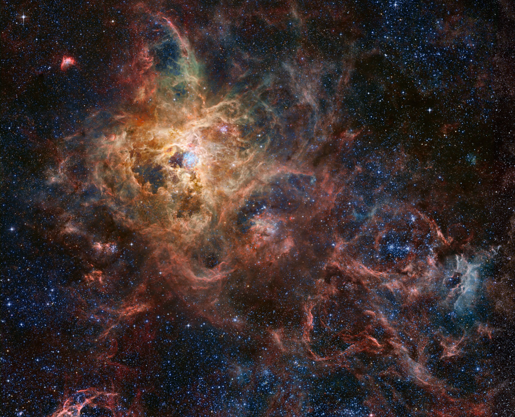 The Tarantula Zone

The Tarantula Nebula, also known as 30 Doradus, is more than a thousand light-years in diameter, a giant star forming region within nearby satellite galaxy the Large Magellanic Cloud. About 180 thousand light-years away, it's the largest, most violent star