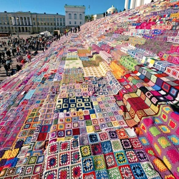 Large-scale yarn bomb at Helsinki Cathedral steps in Finland, 2011. Crocheted squares created 3,800 blankets which were later donated to charity #WomensArt