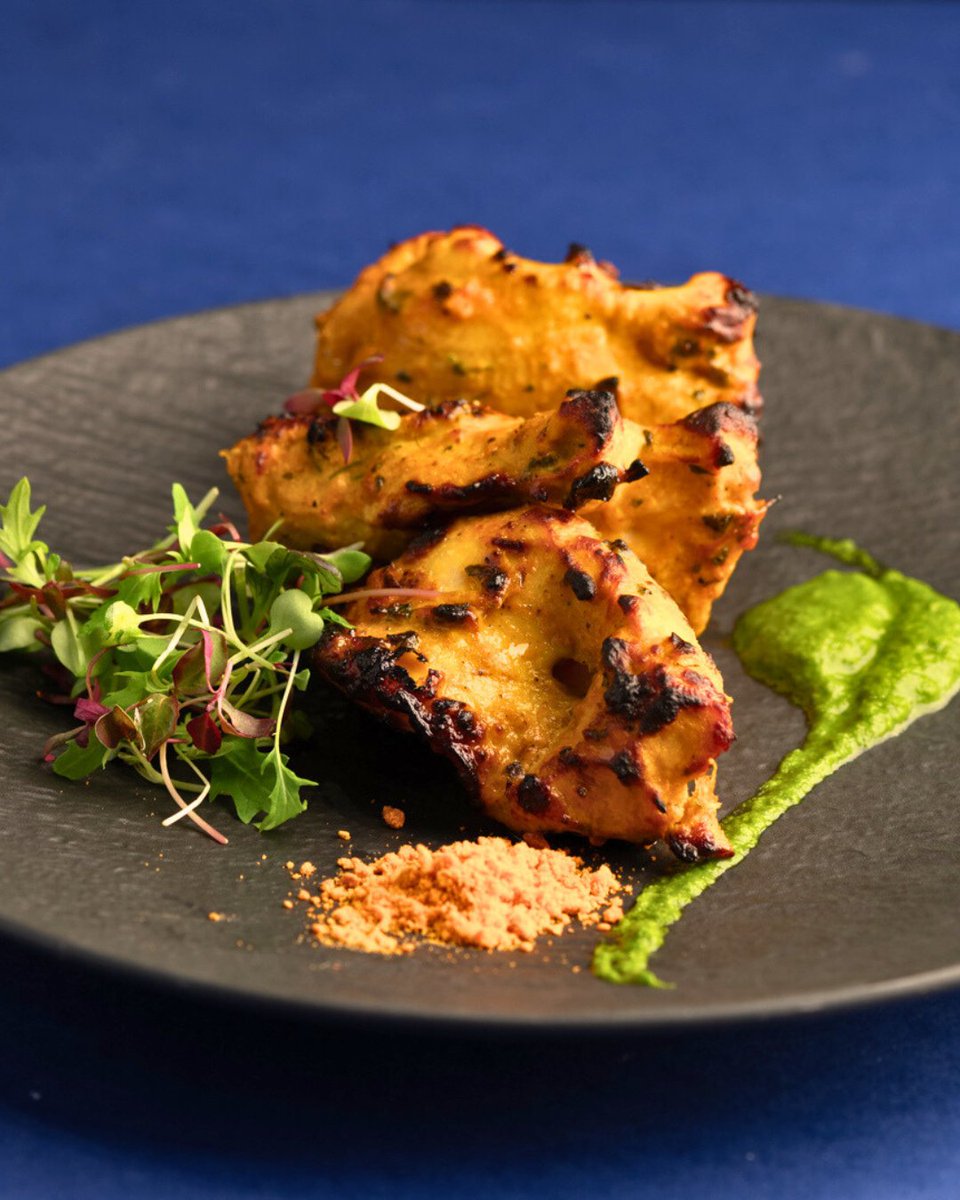 Experience the pinnacle of gourmet indulgence with our Tandoori Chicken, meticulously crafted and elegantly served on a slate of microgreens with a vibrant cilantro coulis. Each succulent piece, perfectly charred and exquisitely marinated, promises a burst of robust flavours.…