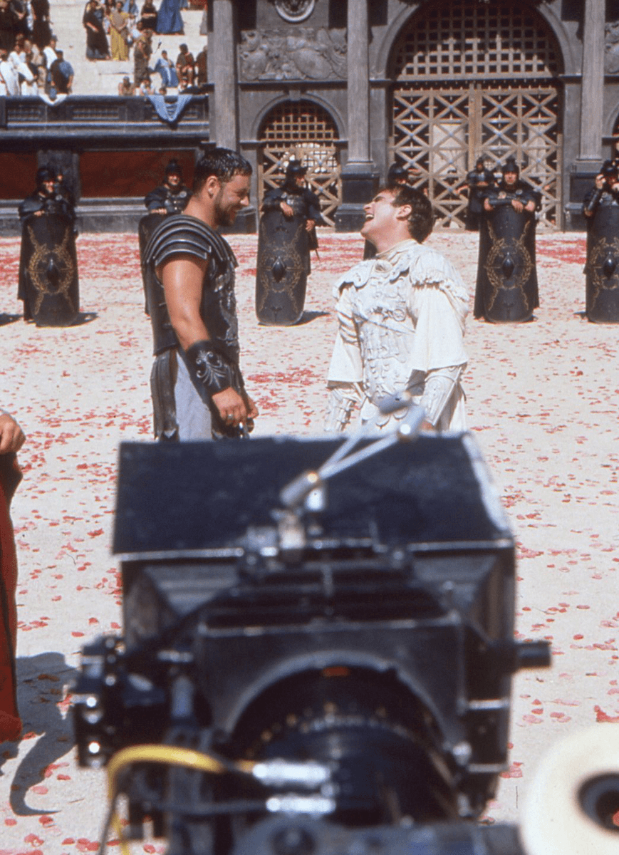 Russell Crowe & Joaquin Phoenix share a joke during the filming of Ridley Scott's 'Gladiator' (2000)
