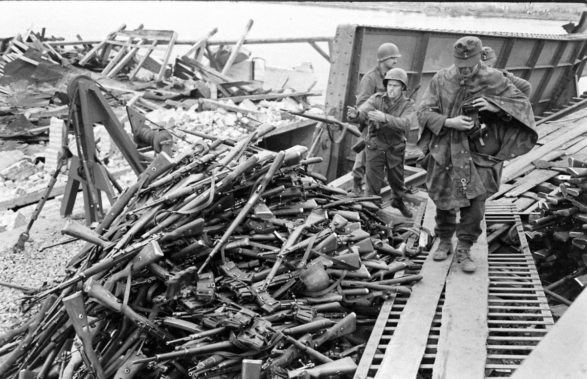 German Personnel turn in weapons while surrendering to US Personnel after crossing the River Elbe using the partially destroyed bridge at Tangermünde to escape advancing Soviet forces between May 4-7 1945
LIFE Magazine Archives - William Vandivert Photographer