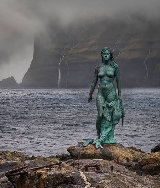 Mikladalur’s Kópakonan on the Faroe Islands - Denmark : Selkies are a variation on the mermaid concept in Scottish, Irish, Icelandic and Faroese folklore. They live in the sea as seals, but can shed their seal hide to become human on land. If their seal skin is hidden or stolen,…