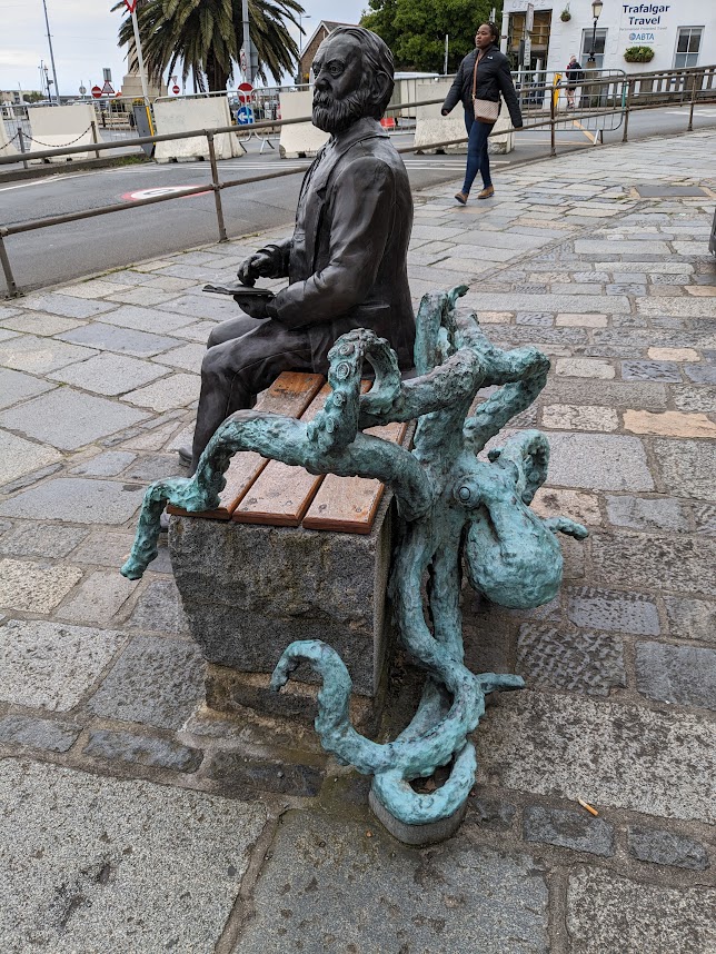 Here is Victor Hugo's bench in Peter Port. He gazes pensively in the direction of his beloved France, apparently unaware of the large octopus preparing an ambush... #Guernsey