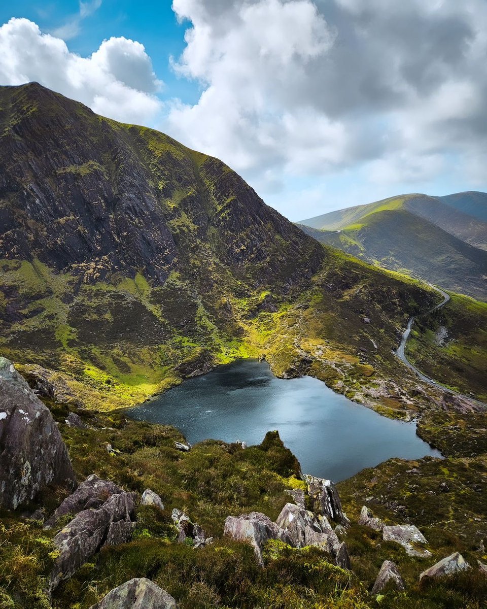 Peddlers Lake, a small lake located in the Conor Pass, Dingle, County Kerry, Ireland.  The lake is surrounded by the foothills of the Brandon Mountains and is a popular spot for tourists, hikers, and campers. 

📸insta @florian_walsh_photography