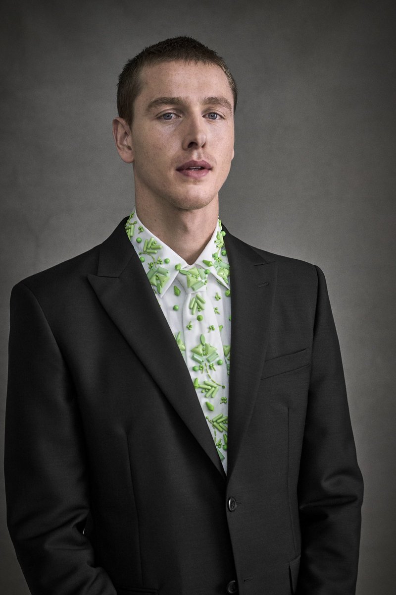 Prada Ambassador Harris Dickinson’s 2024 Met Gala look is embellished with shiny green beads in varying sizes, on a tie that matches his shirt, made by Prada. #PradaPeople #MetGala @metmuseum