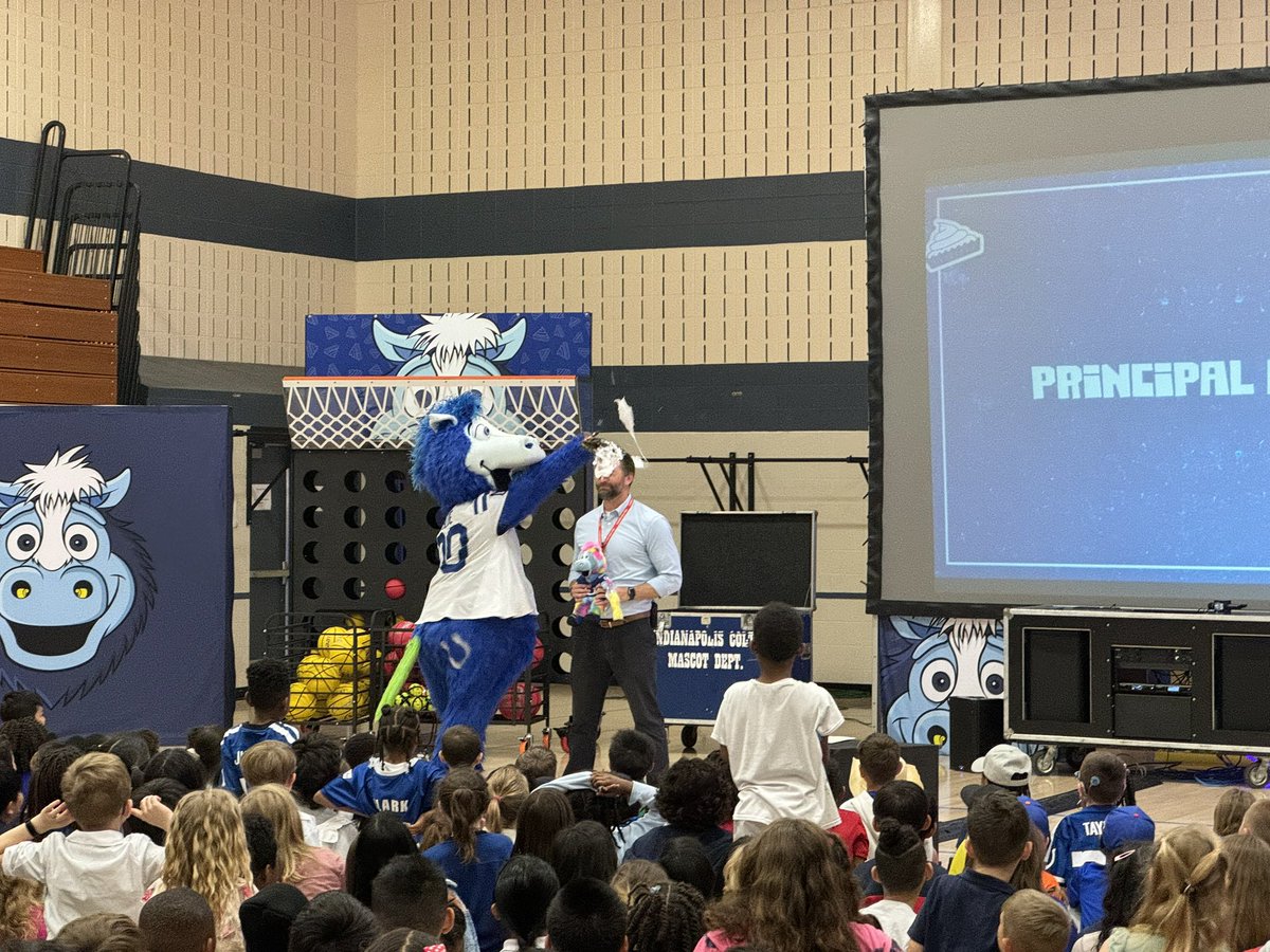 Principal <a href="/mbush36/">Matt Bush</a> takes a pie in the face from <a href="/blue/">Blue</a> Exciting day for RPE students. Thanks to <a href="/Colts/">Indianapolis Colts</a> for spending time in <a href="/perrytwpschools/">Perry Township Schools</a> educating, entertaining, and celebrating our students!