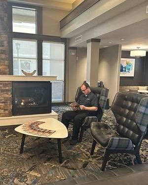 📚✨ Find your cozy corner by the fireplace at Residence Inn Kansas City at the Legends. 📖🔥 #CozyReads #ResidenceInnKC #BookLoversGetaway