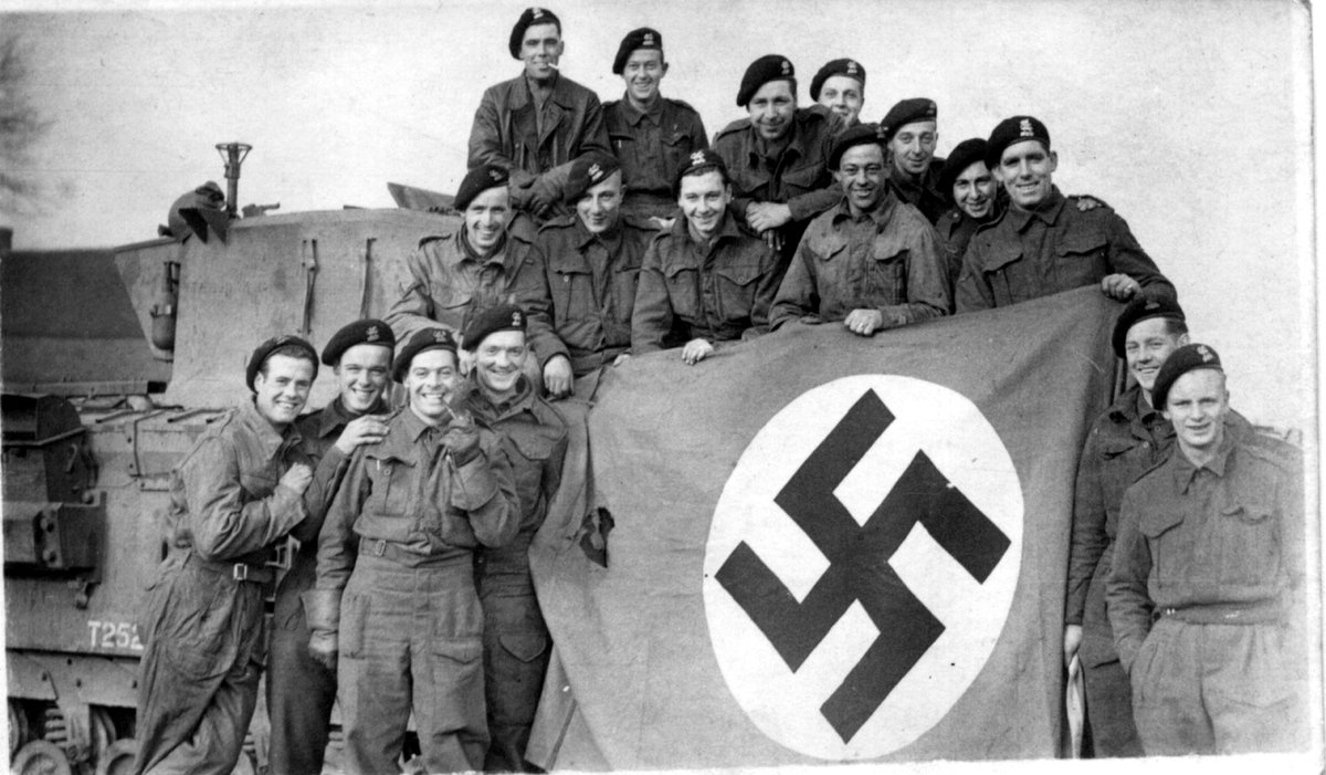 Happy VE Day Everyone!  Here's my Uncle Albert on his Tank with a captured Nazi flag (sitting far right corner of flag).
