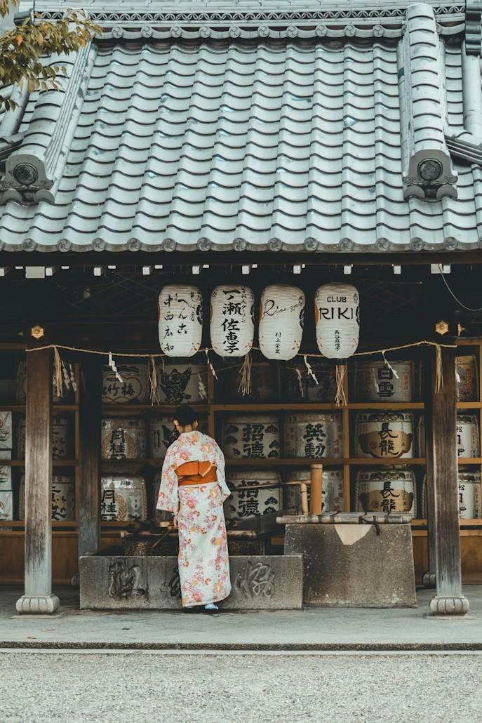 Woman wearing orange and white kimono dress standing near the house... Kyoto \/•\•\/•|\/•• #japan #ExperienceLife